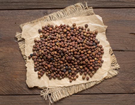 Raw organic roveja beans on a wooden table