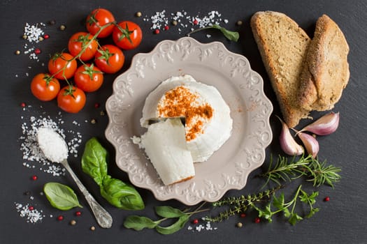 Italian ricotta cheese, homemade bread, vegetables and herbs top view