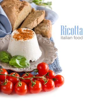 Italian ricotta cheese with bread ad tomatoes isolated on white