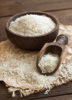 Pile of Basmati rice in a bowl with a spoon close up