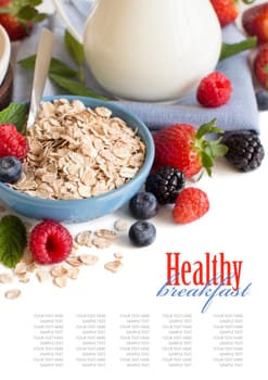 Rolled oats in a bowl with berries and milk isolated on white
