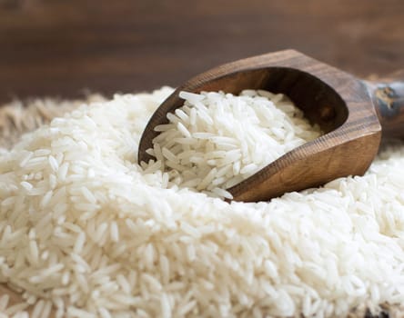 Pile of Basmati rice with a spoon close up
