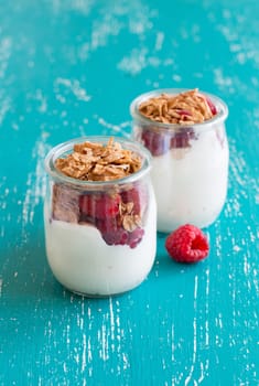Raspberries, flakes and fresh yogurt in a jar
