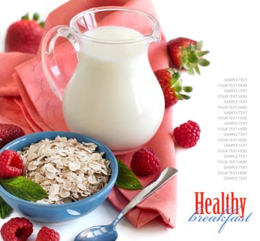 Rolled oats in a bowl with berries and milk isolated on white