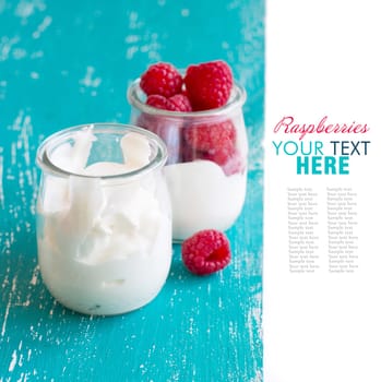 Raspberries and fresh yogurt in a jar on a turquoise background