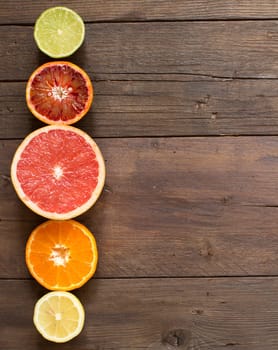 Fresh citrus fruits on a wooden table top view