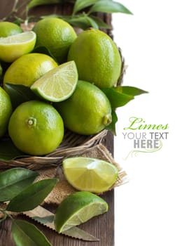 Fresh limes with leaves on a wooden table