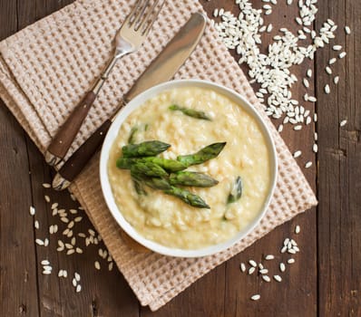 Asparagus risotto with parmesan and taleggio on wood