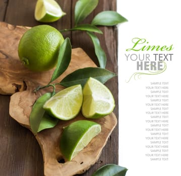 Fresh limes with leaves on a wooden table