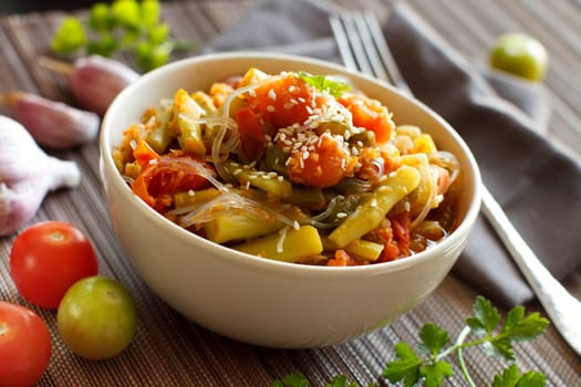 Rice spaghetti with vegetables in a bowl close up
