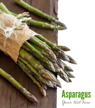 Fresh asparagus spears on a wooden table close up