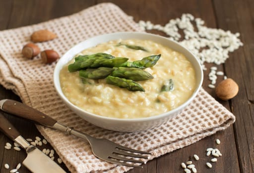 Asparagus risotto with parmesan and taleggio on wood