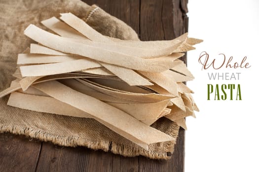 Whole wheat artisan pasta on the old wooden table