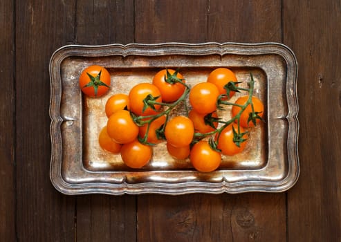 Yellow cherry tomatoes on a metal tray