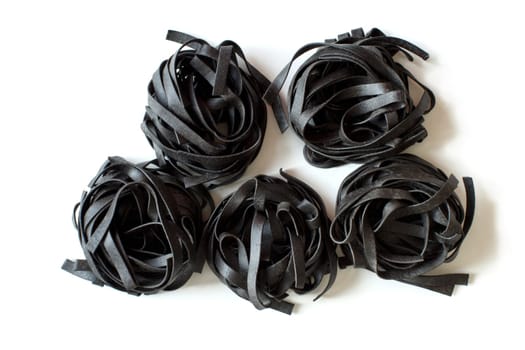 Dry Black Tagliatelle pasta isolated on white background