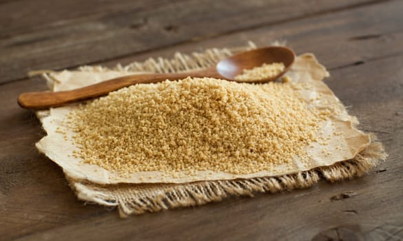 Pile of whole wheat CousCous with a spoon