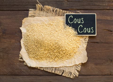 Pile of whole wheat CousCous with a small chalkboard