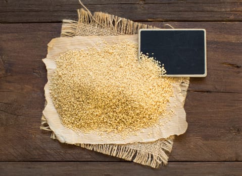 Pile of whole wheat CousCous with a small chalkboard