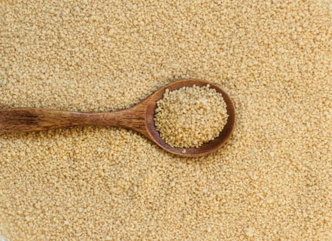 Pile of whole wheat CousCous with a spoon