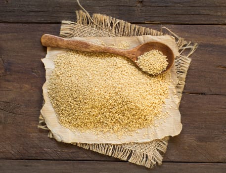 Pile of whole wheat CousCous with a spoon top view