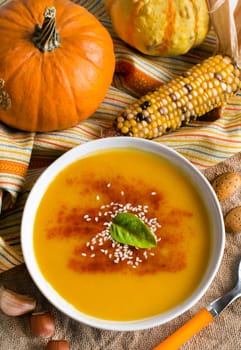 Fresh pumpkin soup and vegetables on a table