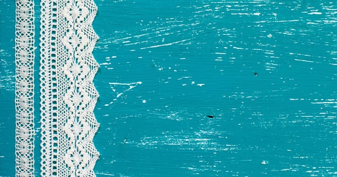Cream vintage ribbons on the turquoise aged wood