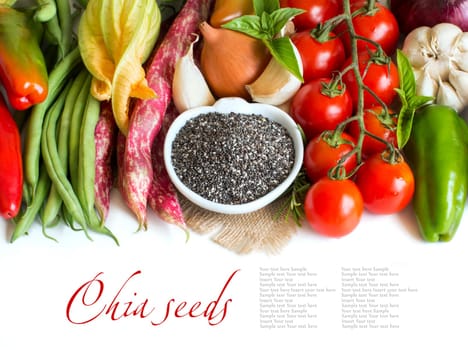 Raw chia seeds in a bowl and fresh vegetables isolated on white