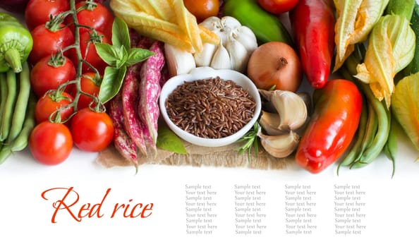 Red organic rice in bowl and fresh vegetables isolated on white