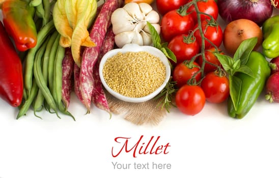 Raw millet in bowl and vegetables isolated on white