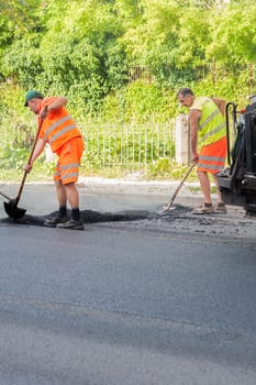 Udine ,Italy - June 28 2016 : Workers on a road construction, industry and teamwork