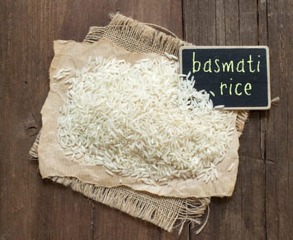 Basmati raw rice on wood with a small chalkboard