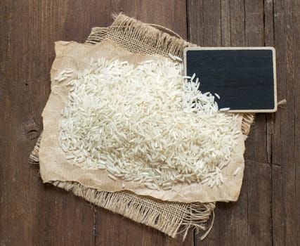 Basmati raw rice on wood with a small chalkboard