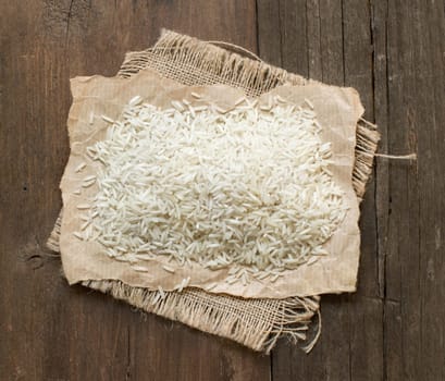 Basmati raw rice on old wooden table top view