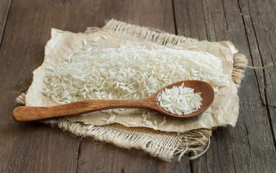 Basmati rice with a spoon on a dark wood