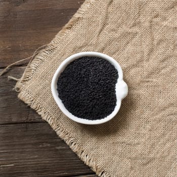 Nigella sativa or Black cumin in a bowl on a wooden background