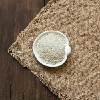 Basmati rice in a bowl on an dark wood