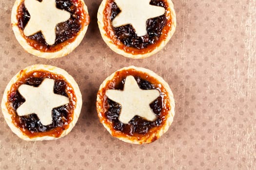 Holiday mince pies with star shape, viewed from above with copy space.