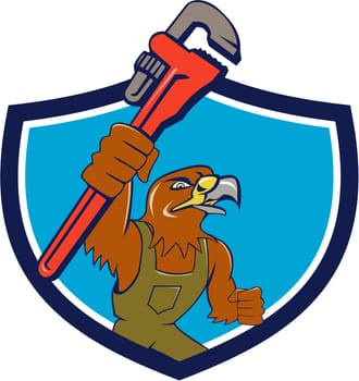 Illustration of a hawk mechanic raising up pipe wrench spanner set inside shield crest on isolated background done in cartoon style.