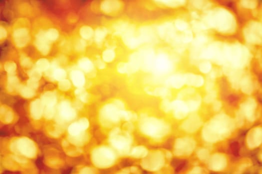 Shining out-of-focus highlights in gold and yellow,a bright bokeh background ideal for autumn or Christmas