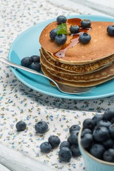 Delicious golden pancakes with fresh blackberries.