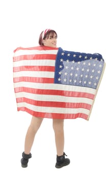 a pretty young woman isolated holding an American Flag, back view