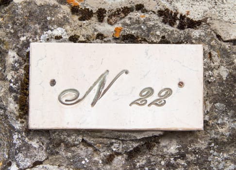Number twenty two on the grey stone wall