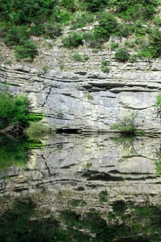 Reflex of climb in mountain lake near Gran Sasso
