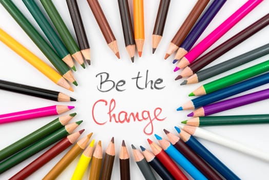 Colouring pencils in circle arrangement with message Be The Change, education concept