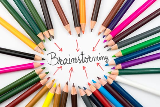 Colouring pencils in circle arrangement with message Brainstorming, teamwork concept