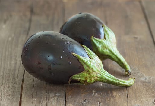 Fresh Ripe Raw eggplants on the wood background