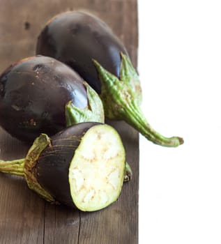 Fresh Raw eggplants on the wood background