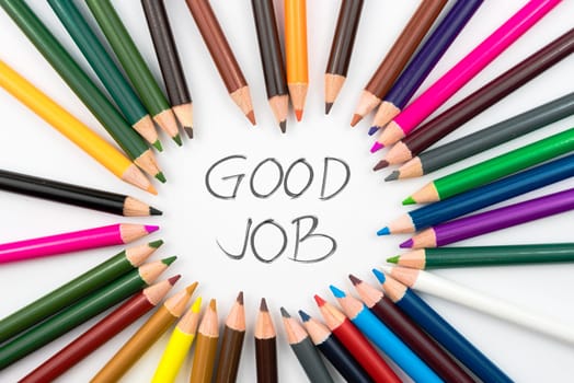 Colouring pencils in circle arrangement with message GOOD JOB, education concept