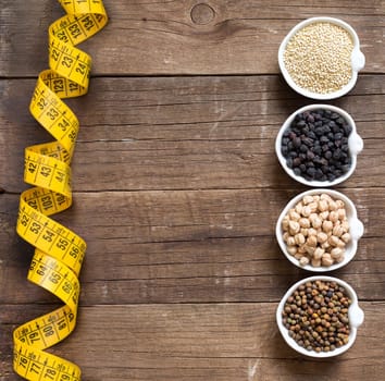 Cereals and legumes in bowls on a wooden table