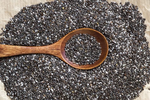 Chia seeds with spoon on a craft paper background